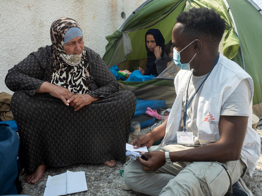 An MSF member of staff speaks with Syrian refugee Jayzah, 67, on Lesvos island, Greece, days after a fire destroyed Moria refugee camp.