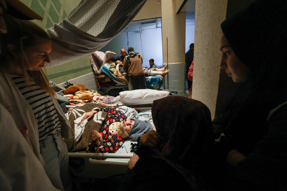 Nurse Katrien Claeys, an MSF team leader, checks on Islam Majdi Al Aydee, a patient at Al Aqsa Hospital in Gaza