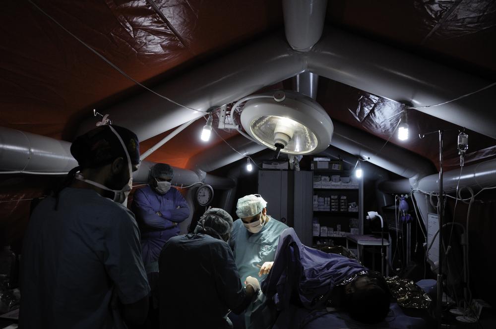 A surgery team inside an inflatable operating theatre.