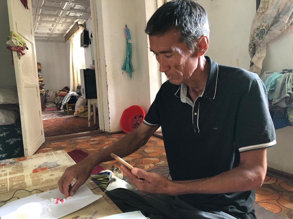 Tuberculosis (TB) patient Embergen, 47, takes his video-observed TB treatment in Nukus, Uzbekistan. 