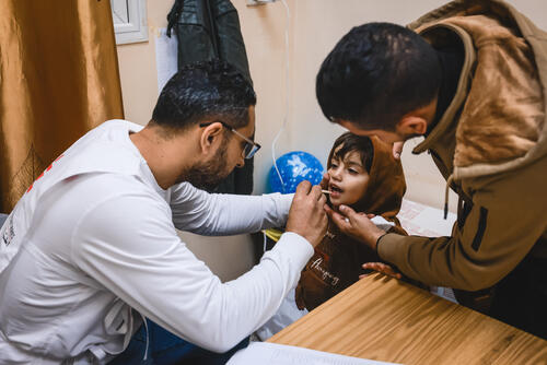 An MSF medic checks on a young patient at Martyrs Clinic in Khan Yunis, Gaza