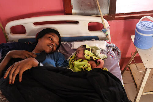 A woman and her baby in a hospital bed