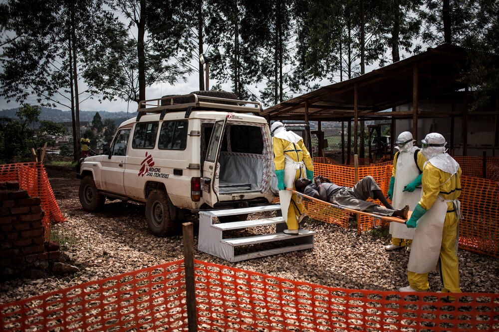 Healthcare workers carry a suspected Ebola patient in the Democratic Republic of Congo