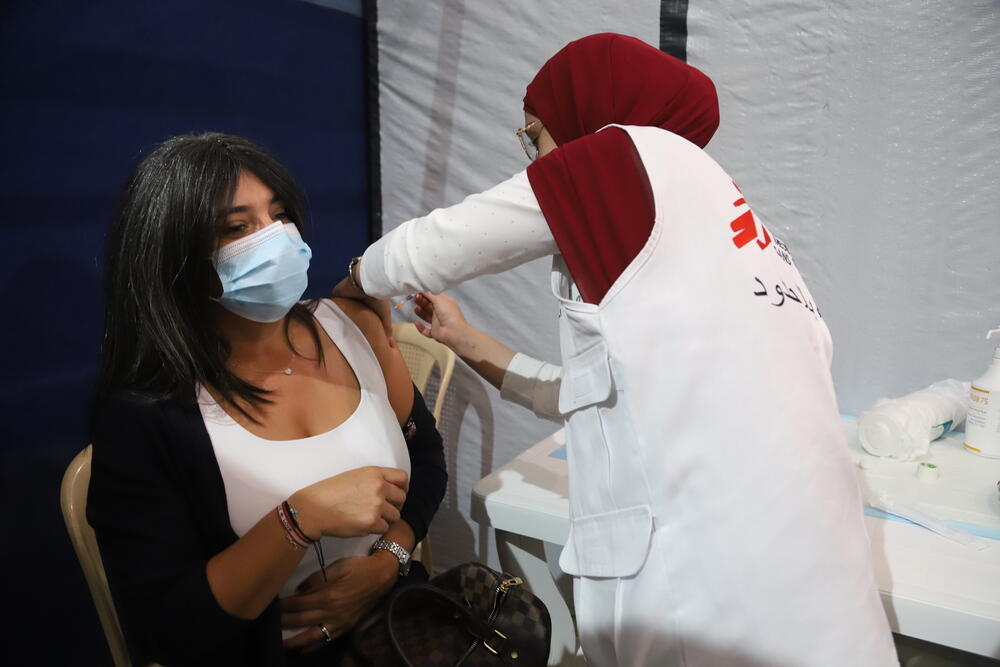 A woman receives a dose of COVID-19 vaccine at the MSF vaccination centre in Bar Elias, Lebanon. 