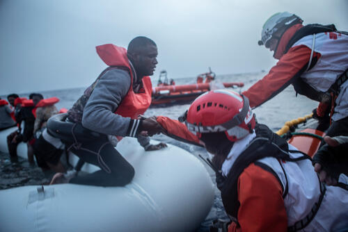 A team from Geo Barents rescuing 113 people from a rubber boat taking on water in the Central Mediterranean