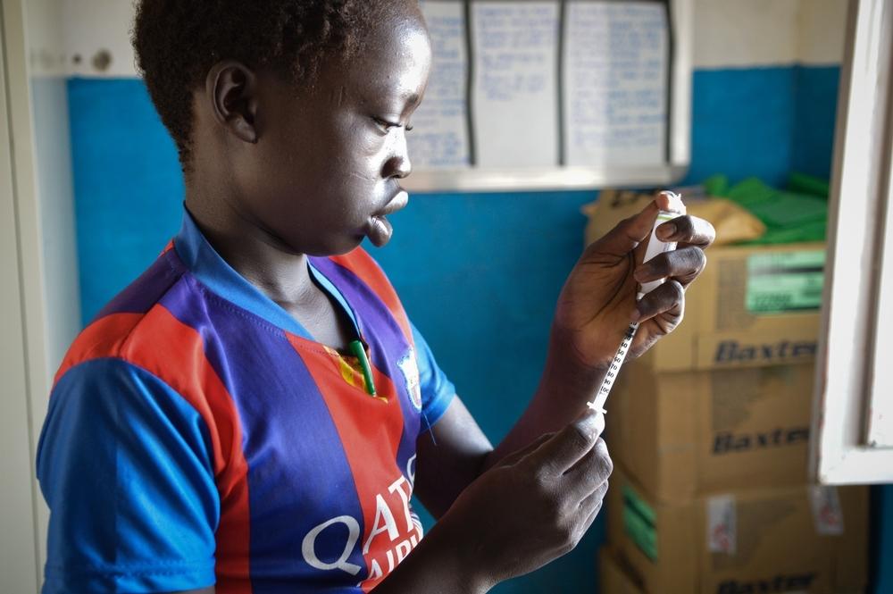 Fourteen-year-old patient Deng Gwin measuring a dose of insulin at Agok hospital