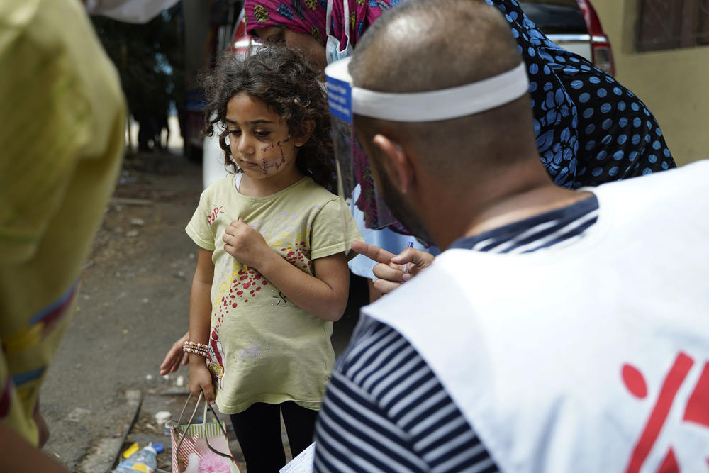 Three-year-old Samar received emergency treatment from MSF for a facial injury sustained in the Beirut blast. Here, a door-to-door team stops to chat with her following her recent reconstructive surgery.