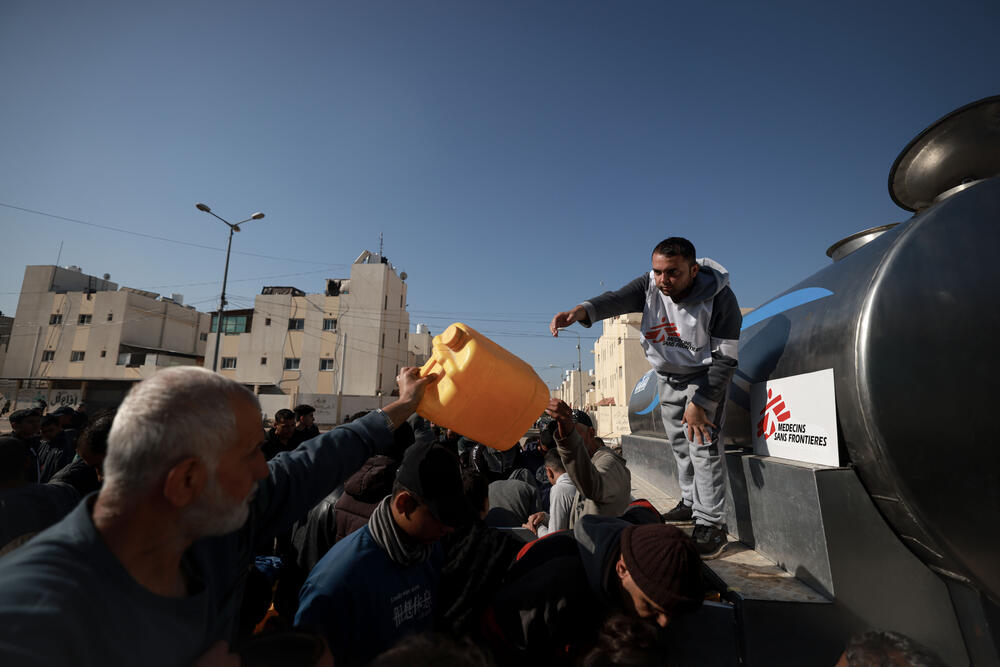MSF water and sanitation specialist Youssef Al-Khishawi oversees a water distribution for displaced people in Rafah, southern Gaza