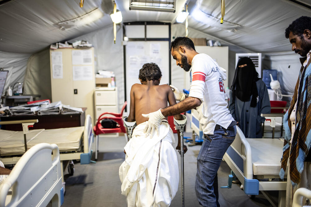 A boy injured by a landmine is helped to walk at an MSF hospital in Mocha, Yemen
