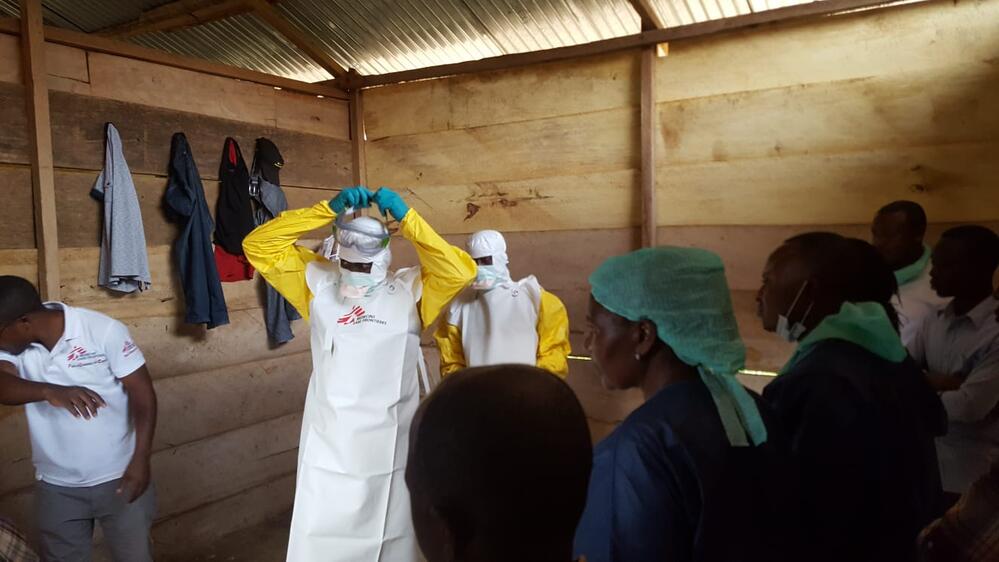 MSF staff don personal protective equipment at the treatment unit for confirmed cases in Mangina, the epicentre of the outbreak