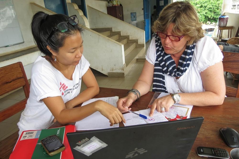 An MSF HR Coordinator goes through a batch of applications with a colleague in Conakry, Guinea.