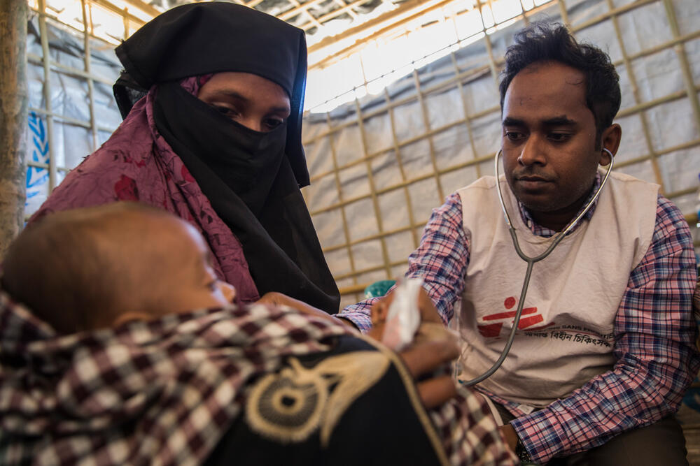 A young boy is examined by a doctor in MSF's clinic next to Nayapara refugee camp. The child's mother, Mumtaz, arrived in Bangladesh in October 2017 to escape the latest wave of violence in Rakhine State, Myanmar. His father died trying to reach Bangladesh.