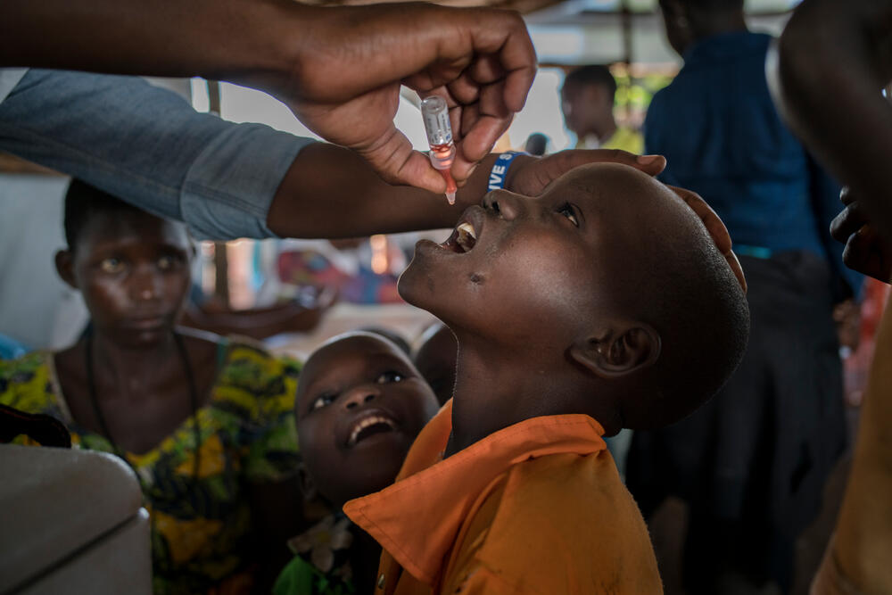 A refugee child receives a polio vaccine in Kyangwali, Uganda. 