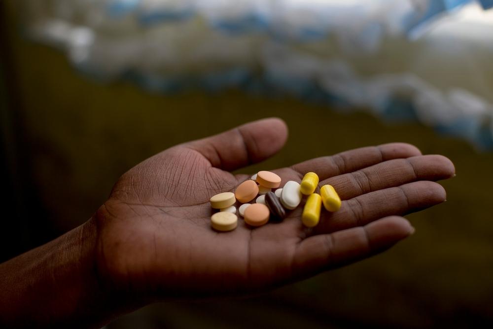 Nanyanyiso Baloi holds her treatment regimen for pre-XDR-TB, which includes delamanid and bedaquiline. Khayelitsha, Western Cape, South Africa, 2016.