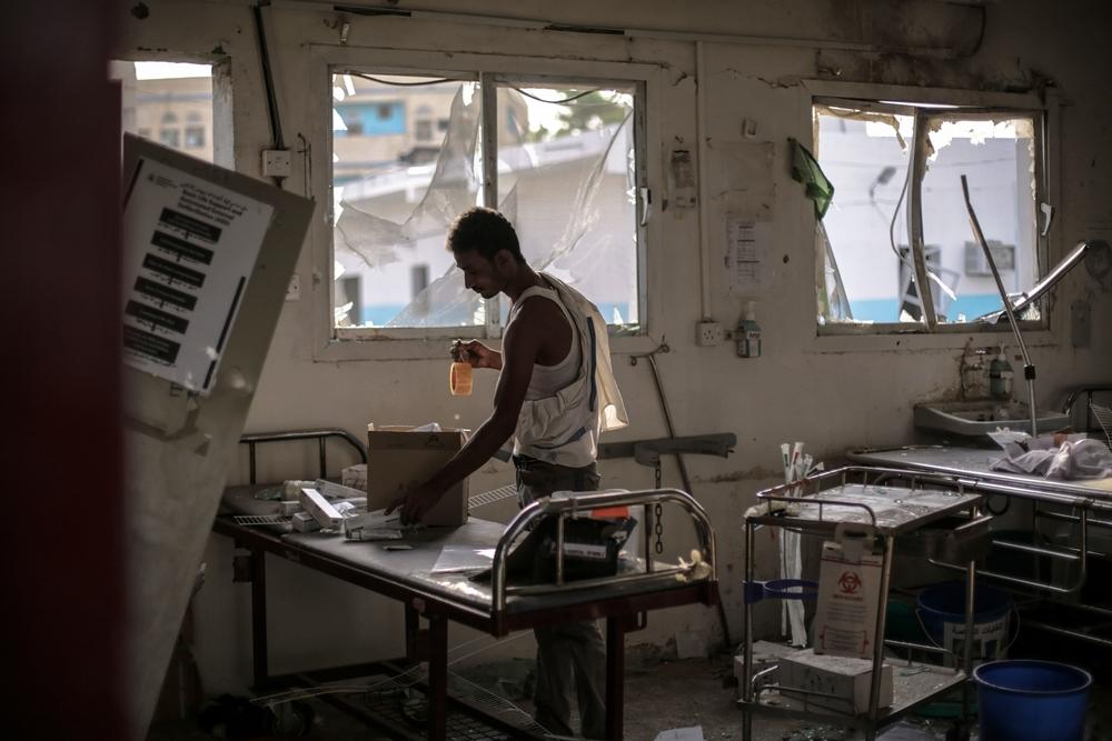 A hospital worker salvages the remains of the emergency room in Abs Hospital after the 2016 Saudi-led coalition airstrike, which killed 19. 