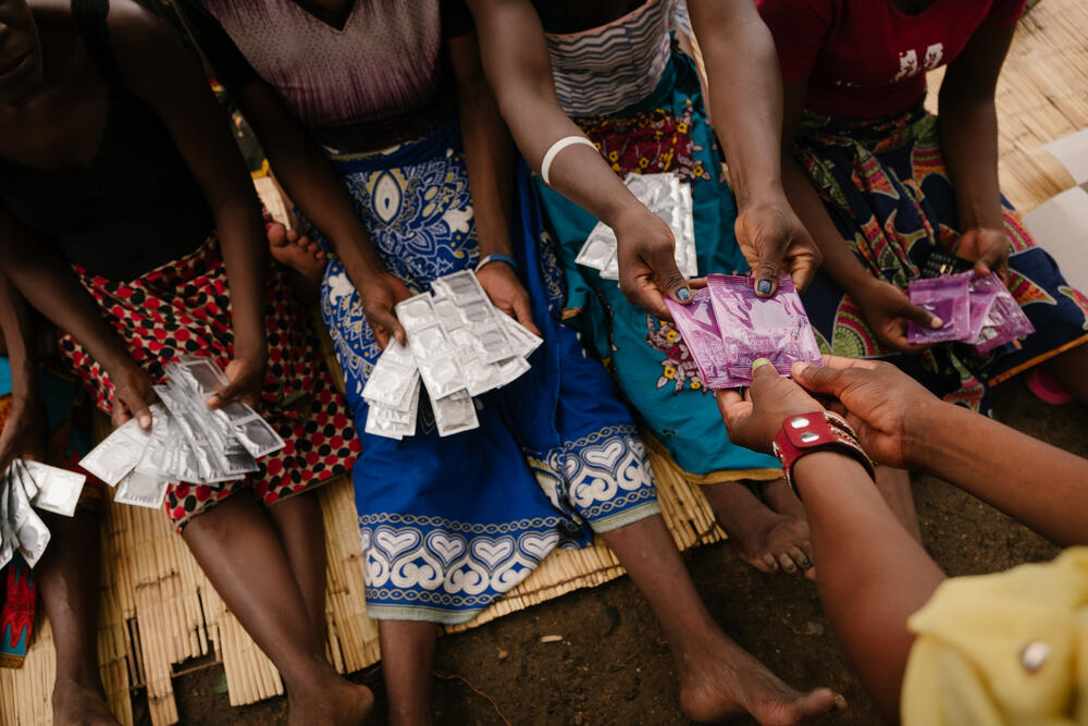 Sex workers receive condoms and lubricant during a health promotion session conducted discretely at a hotspot in Nsanje, Malawi