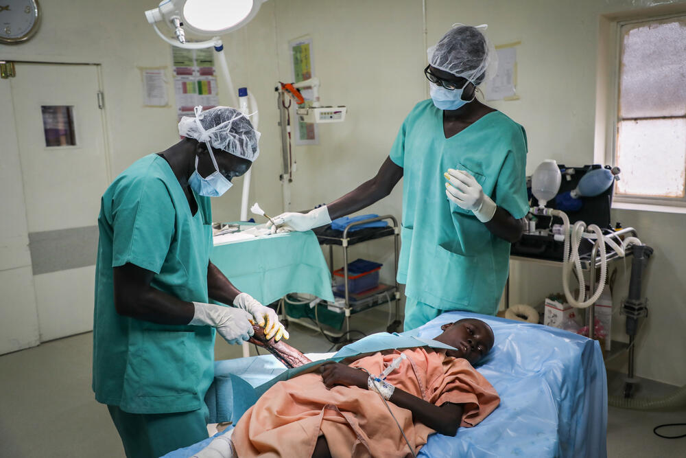 An MSF physiotherapist examines Awien's arm. The treatment must be performed under anaesthesia due to the severity of the pain.