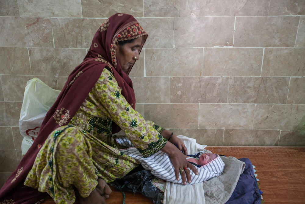 Gulshan's sister swaddles her newborn niece at MSF's hospital in Dera Murad Jamali, ahead of taking her home.