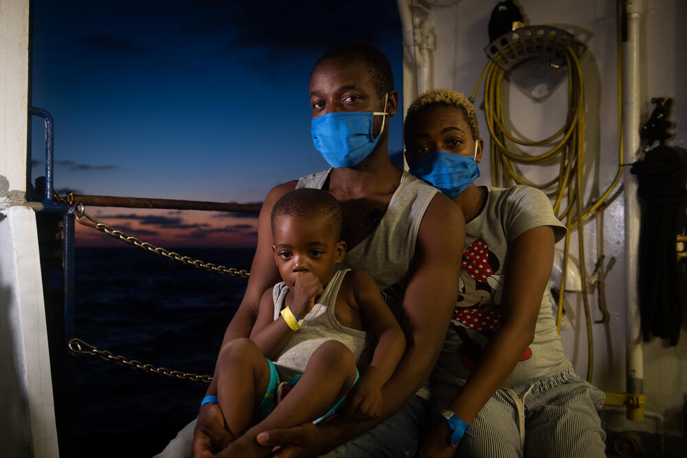 Souleman from Cameroon with his wife and child on the weather deck of the Sea-Watch 4, 27 August 2020.