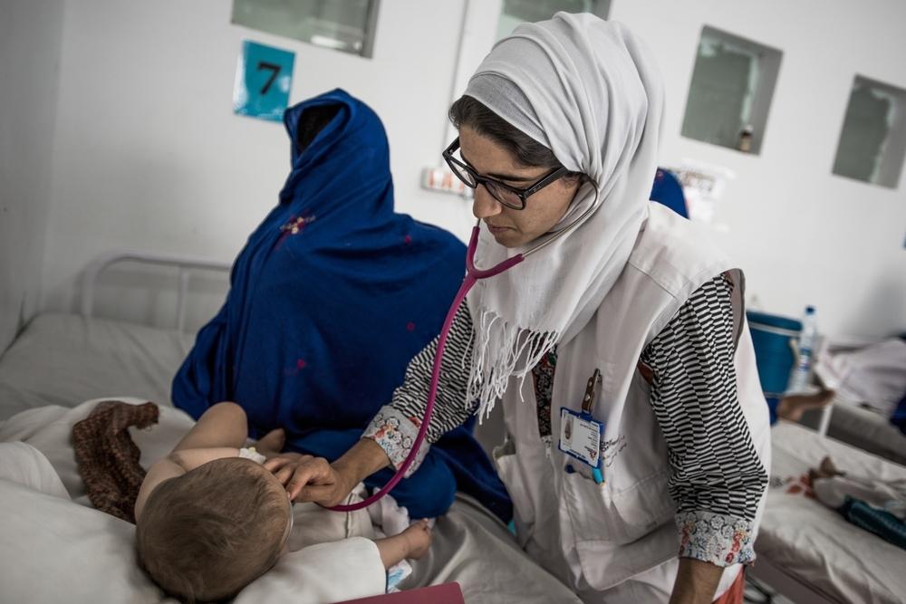 An MSF doctor checking on a child in the paediatric intensive care unit at Boost Hospital, Lashkar Gah, June 2016