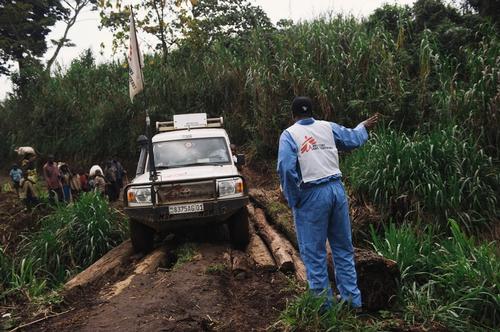 A driver with MSF directs a car over a log-bridge on the road from Nyabiondo towards the village of Kazinga in Masisi territory, in the east of the Democratic Republic of the Congo on August 11, 2014. The bridges would often slide away with the passage of each car, necessitating rebuilding.