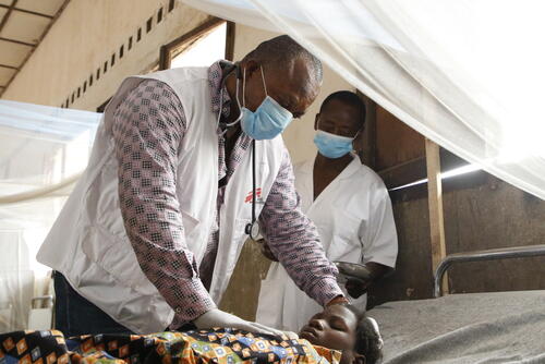 <p>Théophile, médecin des urgences de MSF, examine un enfant rougeole à l'hôpital général de référence de Bosobolo. La zone de santé de Bosobolo dans le Nord-Ubangi est touchée par la rougeole depuis plusieurs semaines. MSF a envoyé une équipe d'urgence pour soigner les patients et vacciner tous les enfants de six mois à neuf ans. En février 2021, une équipe mobile d'urgence de MSF s'est rendue dans la zone de santé de Bosobolo, au Nord-Ubangi, pour soutenir la prise en charge des patients dans huit centres de santé ainsi qu'à l'hôpital général. L'équipe a lancé la vaccination de 66 000 enfants dans cette zone de santé isolée, et formé des agents de santé locaux à la prise en charge des patients et à la surveillance épidémiologique.</p>
