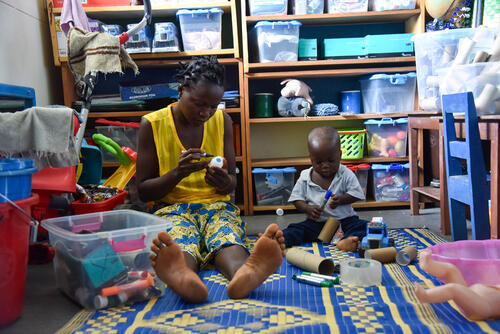 One-year-old Morrison and his mother Adama engage in an individual play session at MSF Mother and Child Hospital in Sierra Leone