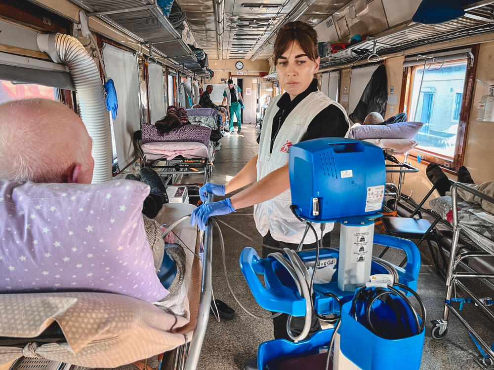 MSF nurse Halyna Milovus checks the blood pressure of a patient on board the MSF medical evacuation train