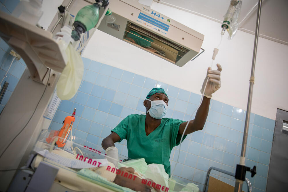 Serge, an MSF anaesthetist, taking care of a newborn admitted to the surgical unit of a hospital in Cameroon.