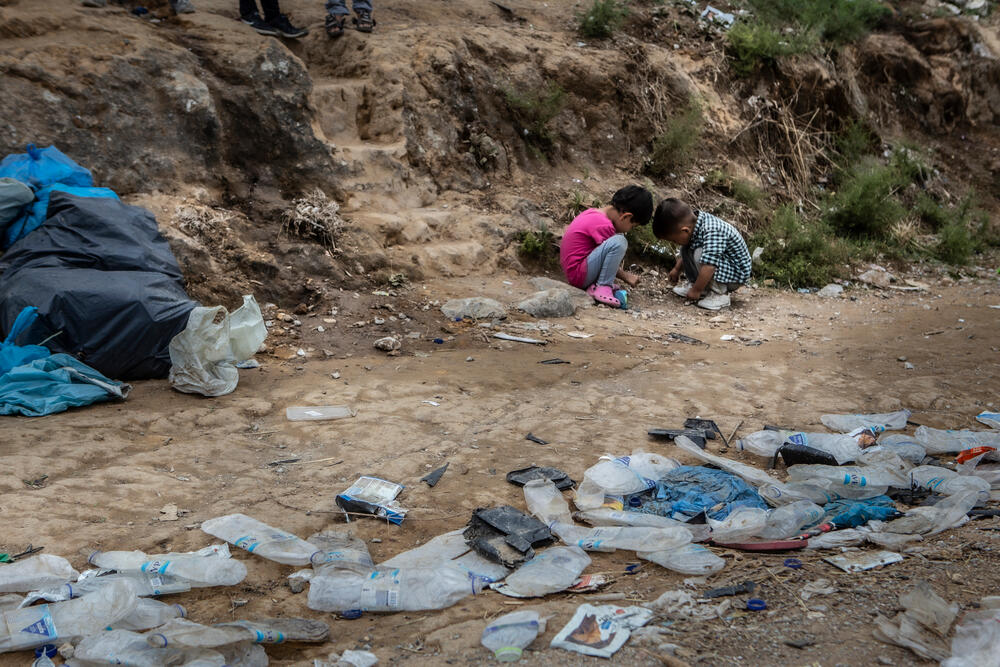 Two children play among rubbish in the area known as 'Olive Grove' next to Moria camp on Lesvos.