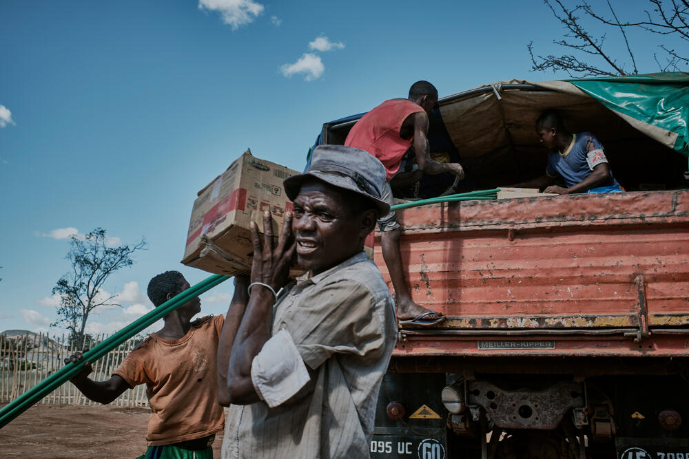 The MSF team unload ready-to-use therapeutic food at the mobile clinic.