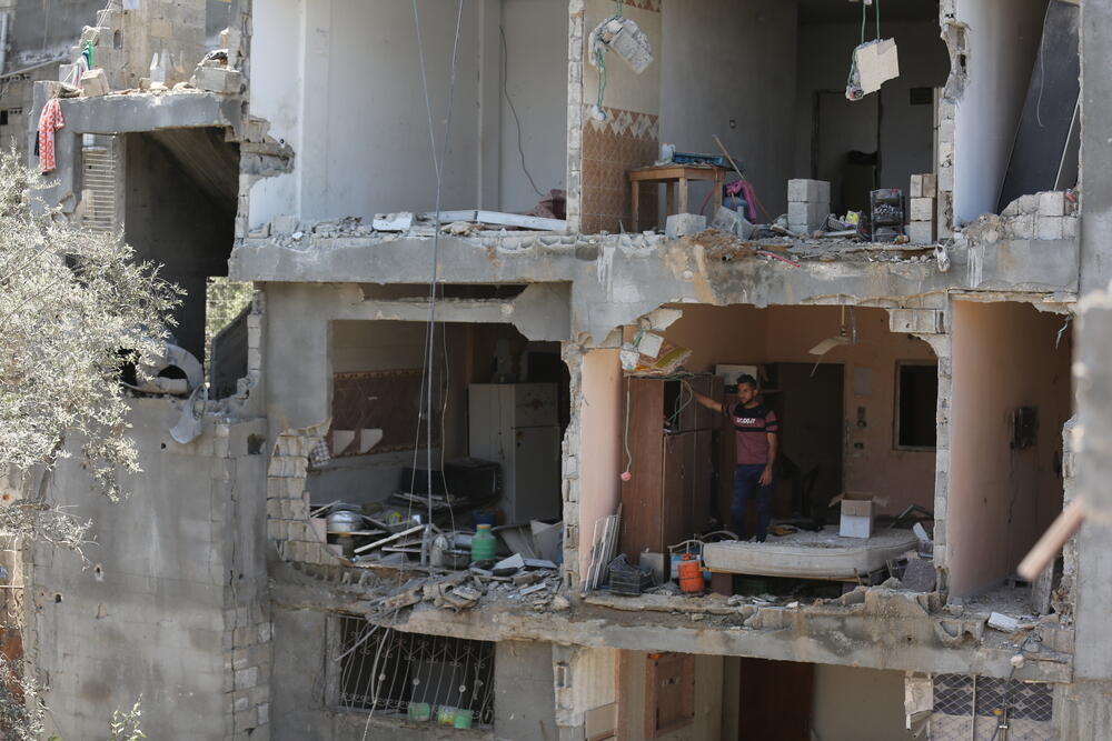 A Palestinian man stands inside a destroyed apartment in Gaza city