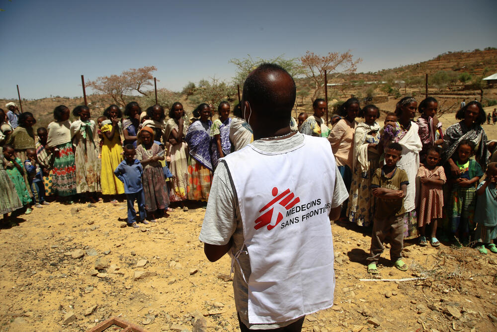 An MSF translator gives instructions to women waiting with their children for a medical consultation at a mobile clinic in the village of Adiftaw, in the northern Ethiopian region of Tigray.