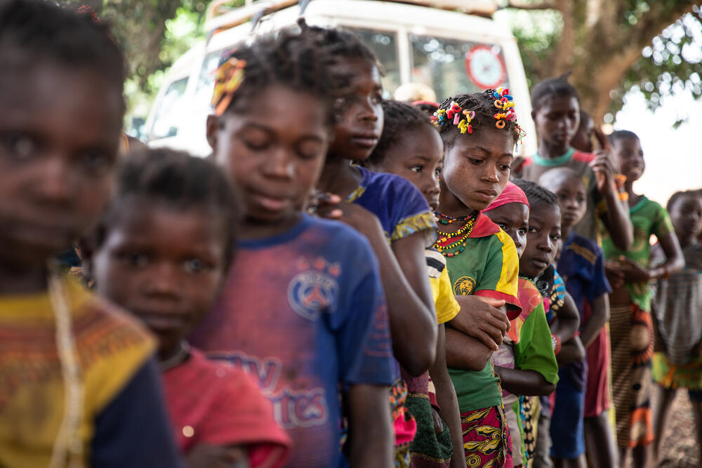 Nervous children stand in line, waiting to be vaccinated against measles in the village of Ndongue.