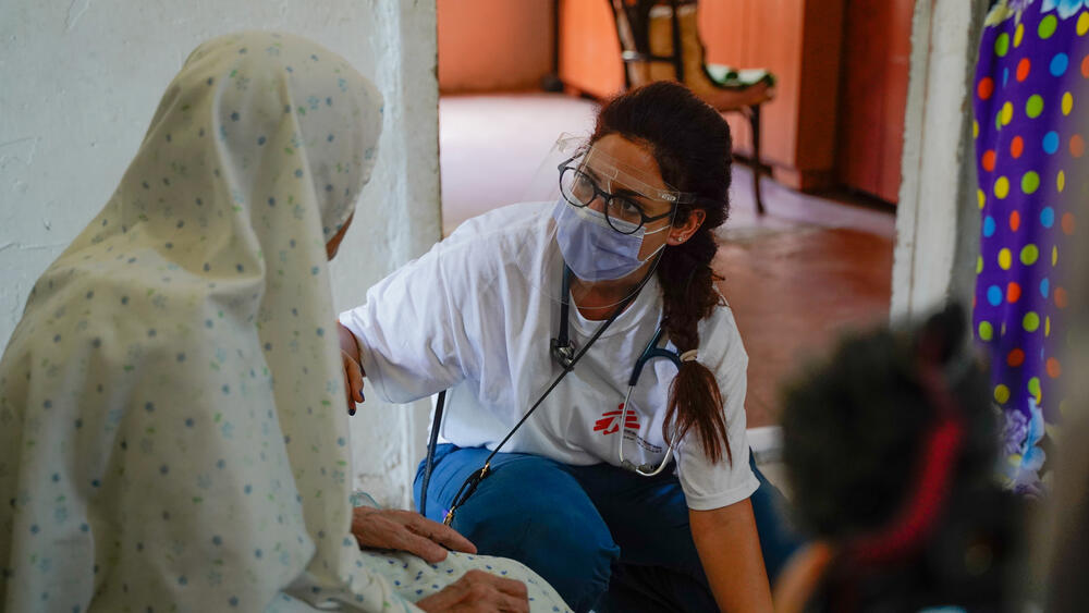 An MSF doctor consults with Fatima, an elderly woman who was on her balcony when the blast happened. She stood still while the doors were ripped off and the glass shattered.
