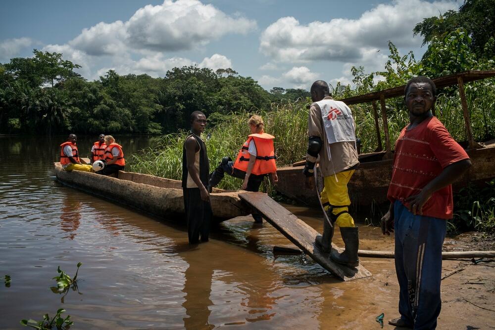 MSF staff board a pirogue - a long, narrow canoe made from a single tree trunk - to cross a river on their 125 km journey from Bondo to Monga, in Democratic Republic of Congo. 