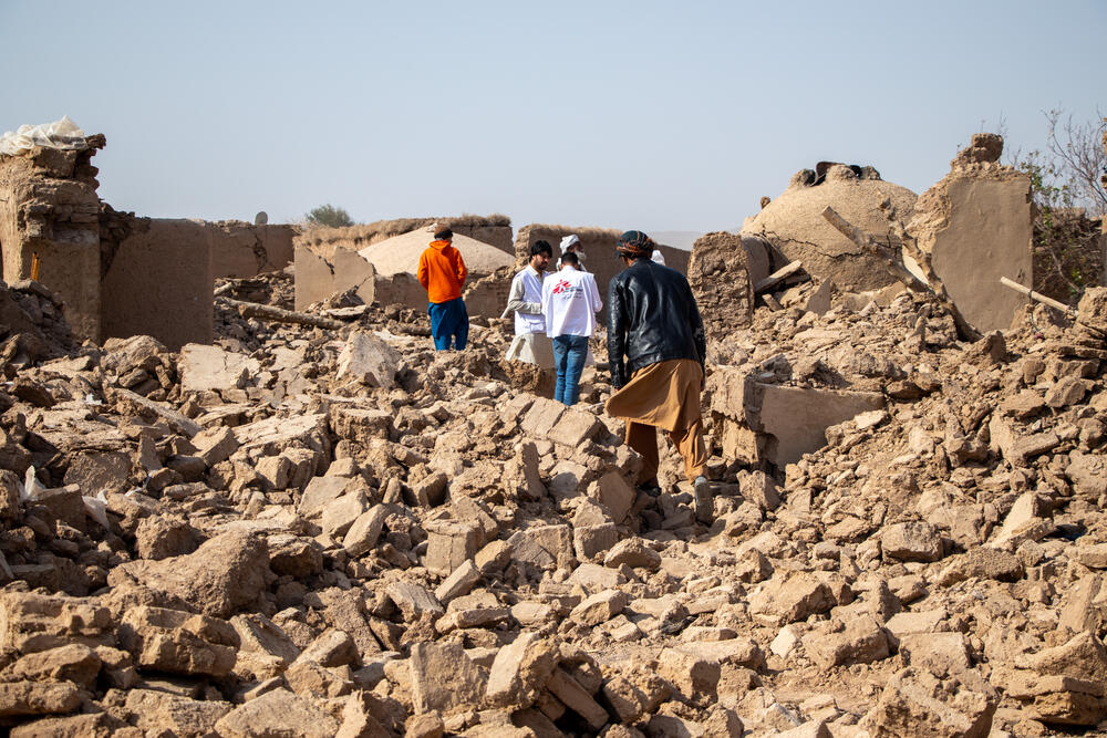 MSF staff walk over the rubble of what used to be people’s homes in Sanjaib Village, Injil District, Herat Province. The team is conducting an assessment of the population’s needs following the earthquakes in the province. All houses in the village were destroyed..