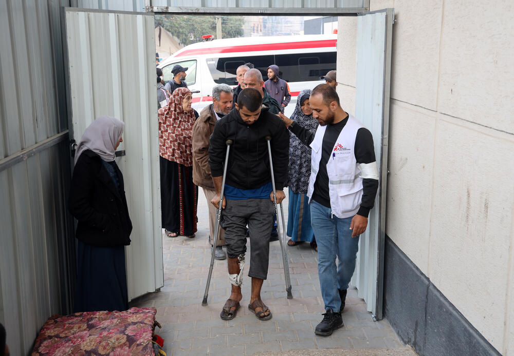 A patient is helped into the MSF clinic at Rafah Indonesian Field Hospital in the south of the Gaza Strip