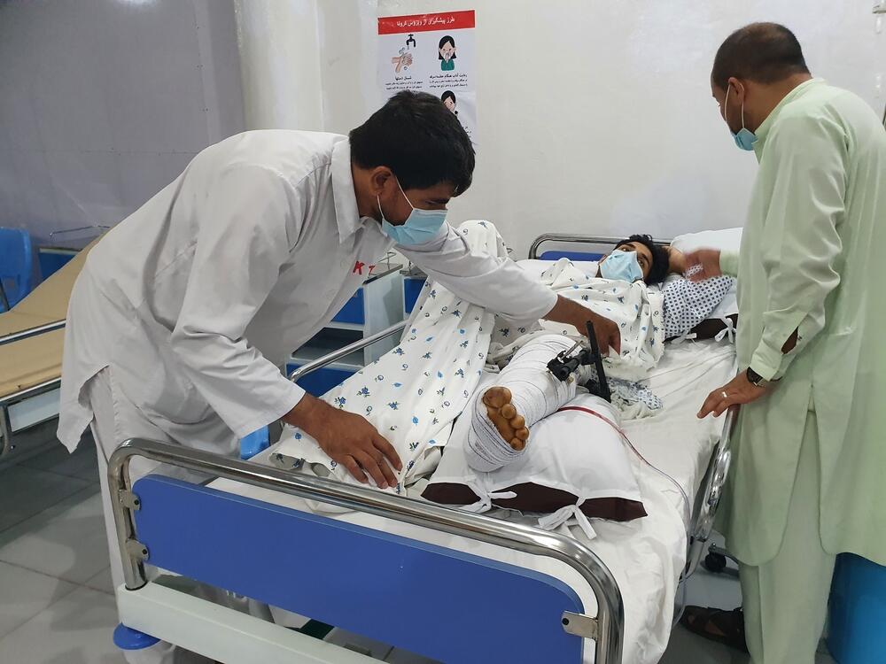 A medic in our temporary trauma unit in Kunduz treats a patient who has suffered a complicated fracture of their upper and lower leg due to a bomb blast. 30 July 2021.