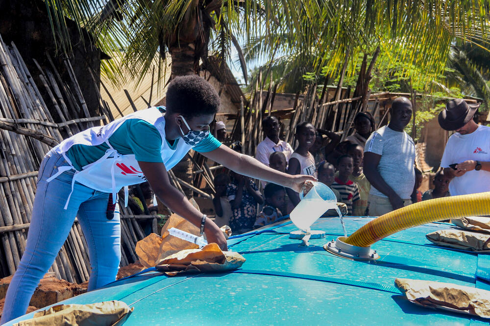 An MSF water and sanitation specialist managing water treatment at a distribution site in the Natiti neighborhood of Pemba, Tanzania.