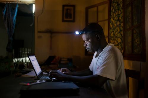 Jean Liyolongo, Head of Monga Intervention, works late into the night at the MSF base, Monga, in Bas-Uele Province, Democratic Republic of Congo.