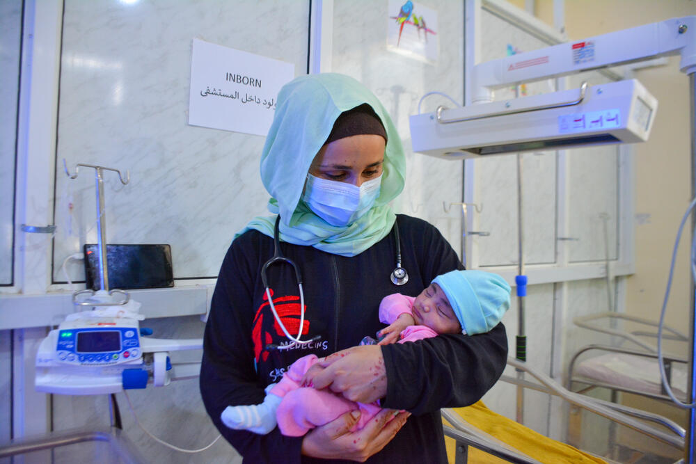 MSF paediatrician Monica Costeira holding a baby in the neonatal unit of Al-Qanawis Hospital in Yemen