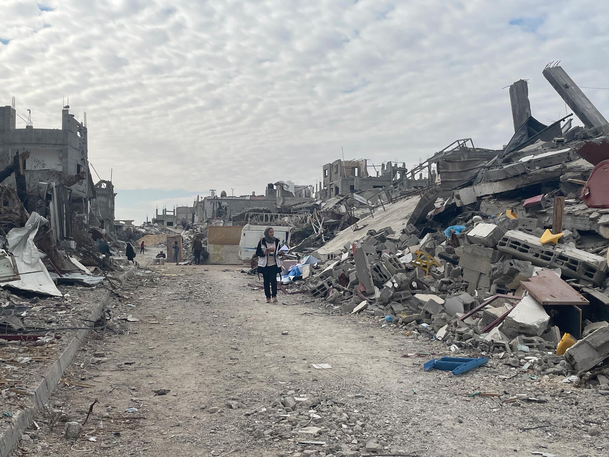 MSF’s Nadia Abo Malloh walking through the ruins of Rafah city, southern Gaza, Palestine.