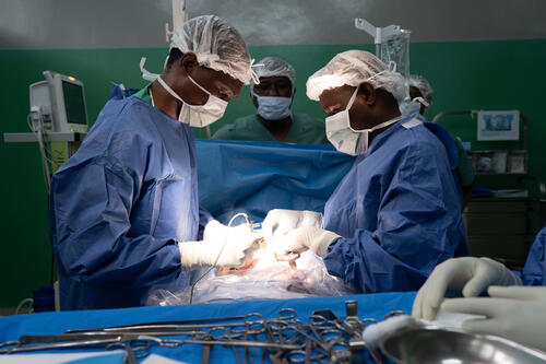 Surgeons at the Rutshuru General Reference Hospital cauterise a wound of a young gunshot victim.