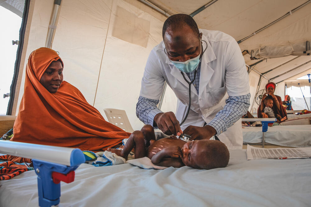 Dr Bukar M. Galtimar examining a severely malnourished child admitted to the inpatient therapeutic feeding centre (ITFC) at Nilefa Kiji nutrition hospital run by MSF in Maiduguri, Borno State in Nigeria.