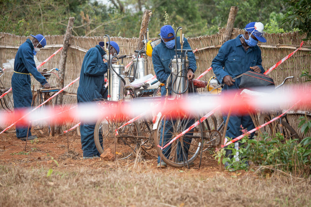 A spraying team is getting ready to treat a house against mosquitoes on the Ruyaga hill, Kinyinya health district