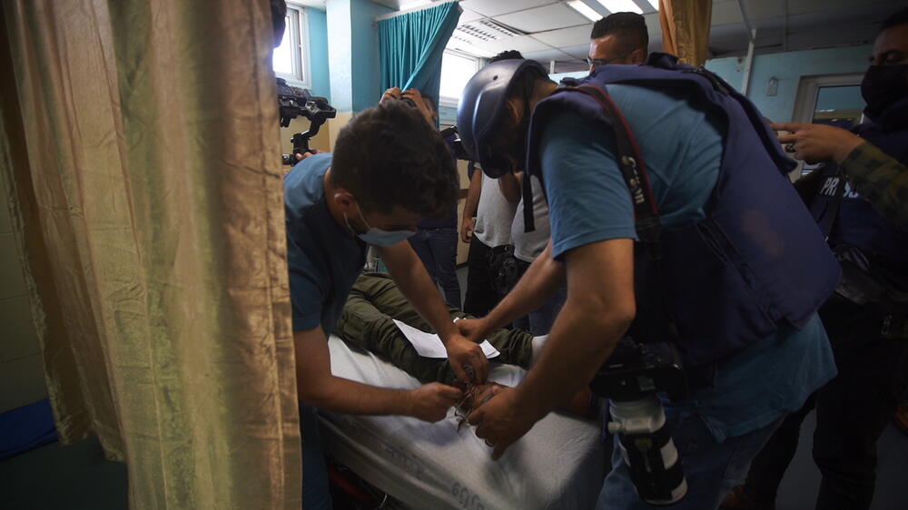 A Palestinian receives medical services after being injured, 19 May 2021. 