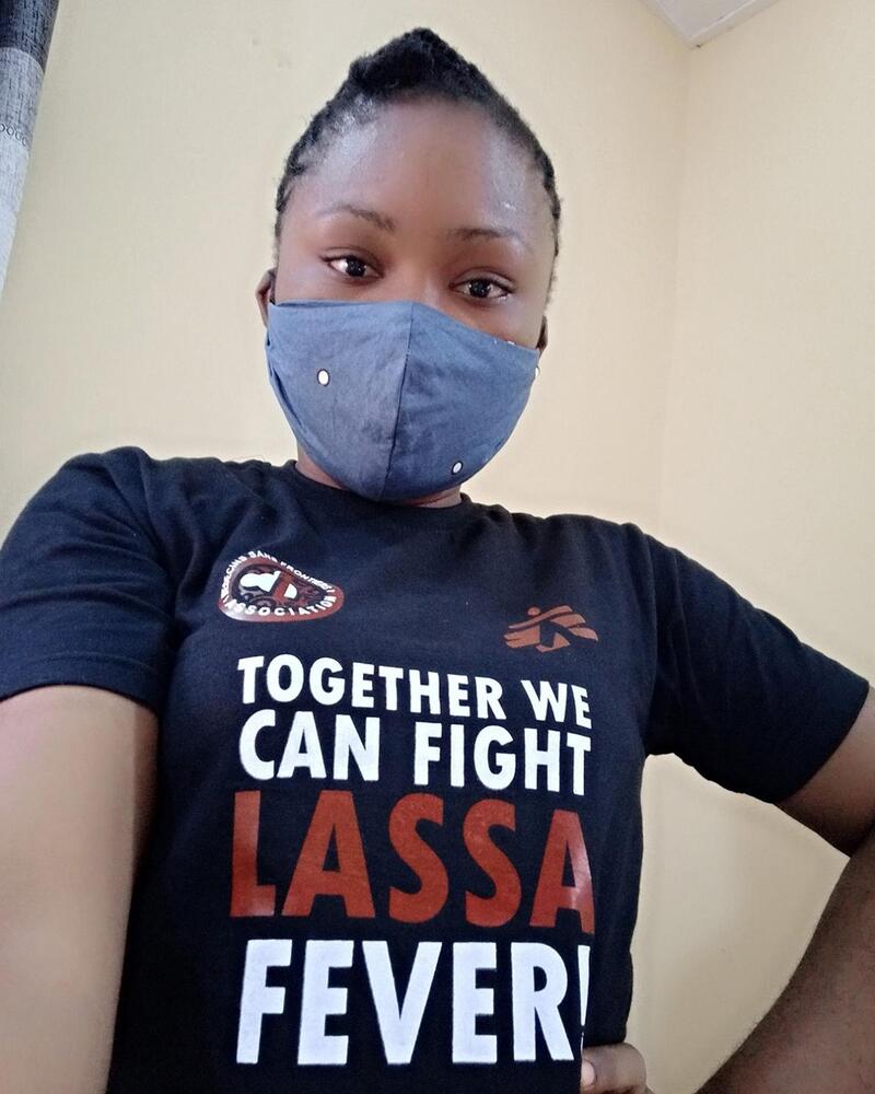 Shirley Samson wearing a T-shirt with a health promotion message about Lassa fever