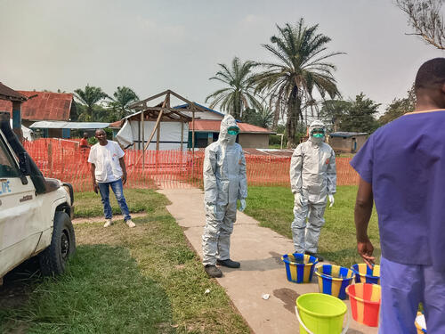 Photo of medical staff in protective equipment outside
