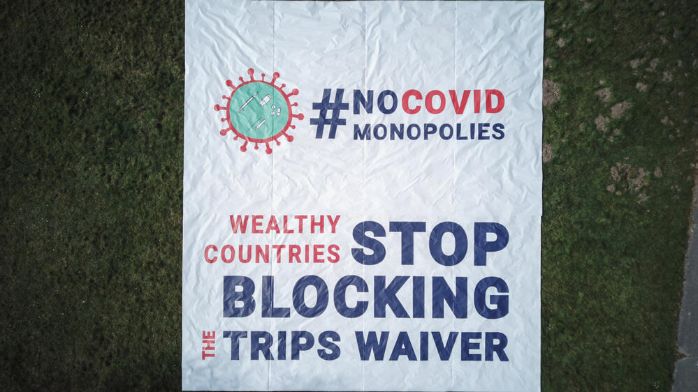 Aerial view of the banner in front of the World Trade Organization (WTO) in Geneva calling on governments to stop blocking the waiver proposal on intellectual property (IP) during the pandemic.
